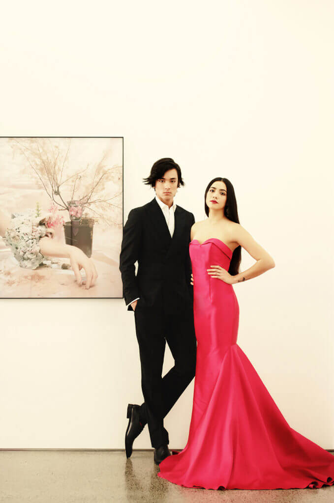 Matt wears Crane Brothers Calando Tuxedo $2695, Rembrandt Black Leather Whole-Cut Shoe $399. Mikayla wears Modes Zeila Dress $898, Modes Bronze Pearl & Crystal Art Deco Earrings $169.