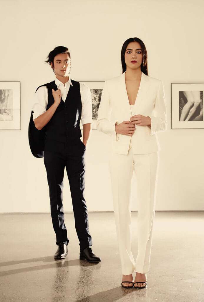 Matt wears MJ Bale Saunders Jacket $769, MJ Bale Saunders Trouser $299, MJ Bale Saunders Waistcoat $219, MJ Bale Owens White Shirt $89.95, Rembrandt Black Leather Whole-Cut Shoe $399. Mikayla wears Contemporary Tailors Three Piece White Suit designed by Serena Kelsey contempoarytailors.co.nz, Stuart Weitzman ‘Song’ Sandal exclusive to Scarpa $590.