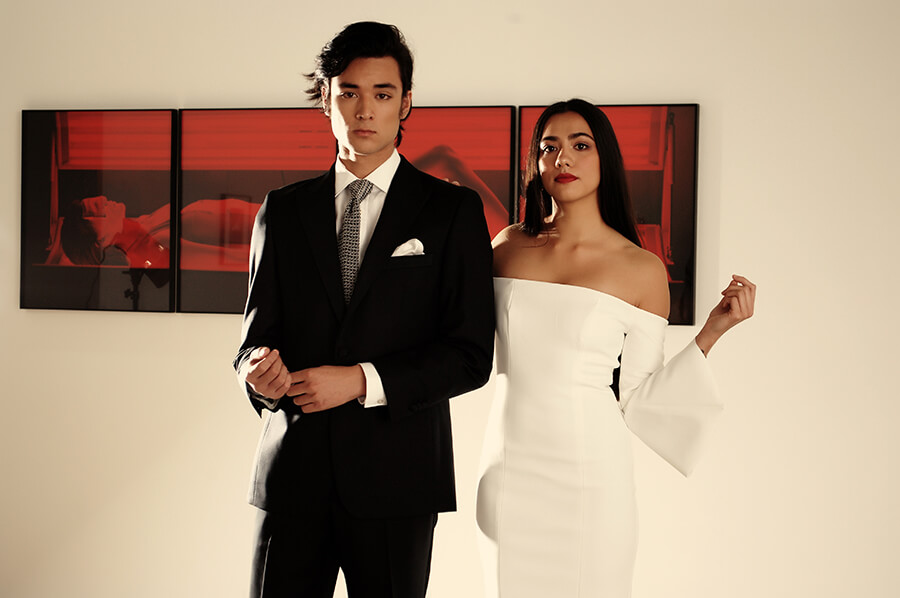 Matt wears Working Style Black Grosgrain Dinner Suit $1490, Working Style Marcella Dinner Shirt $249, Working Style Houndstooth Knitted Silk Tie $149, Working Style White Silk Pocket Square $99. Mikayla wears Kookai Florence dress $240.