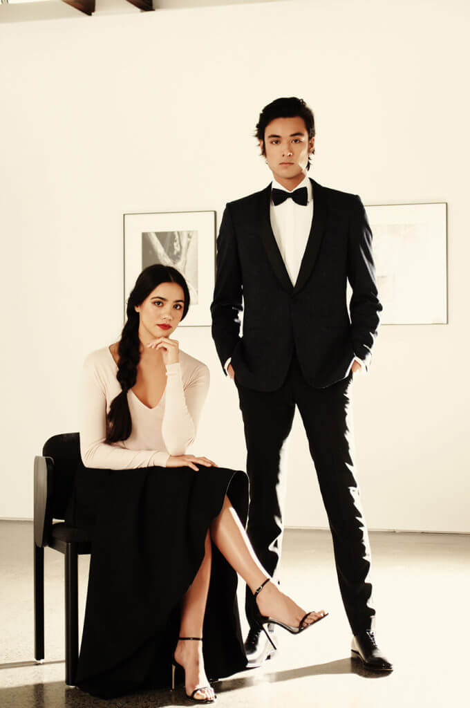 Mikayla wears Pearl Culture Angie skirt 100% Silk $550, Pearl Culture Monroe Cashmere silk sweater $380, Stuart Weitzman ‘Song’ Sandal exclusive to Scarpa $590. Matt wears Rembrandt Bryan ‘SV’ Jacket $599, Rembrandt Avalon Shirt $169, Rembrandt Ferry Formal Trousers $279, Rembrandt Black Leather Whole-Cut shoes $399.